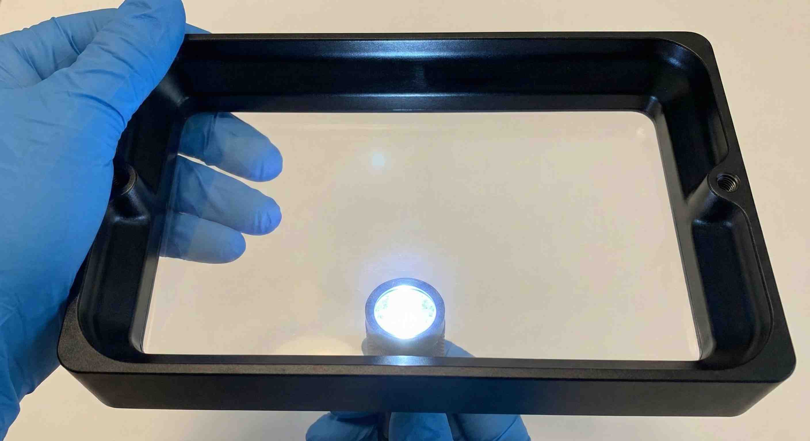 Inspecting clean FEP film for damage and clarity – check for scratches and cloudiness